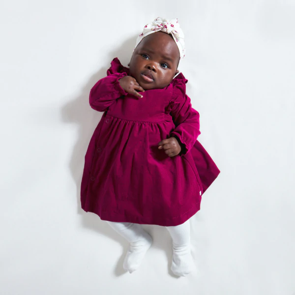 Newborns' dress in fine ribbed pink corduroy