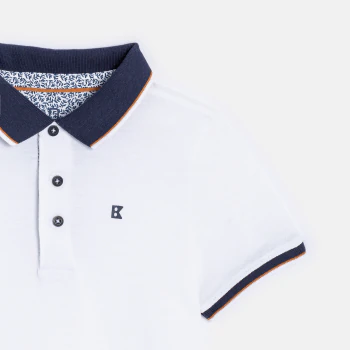 Boy's white cotton piqué polo shirt with short sleeves